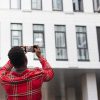 Man taking photo of a building | Financing Affordable Housing in Real Estate