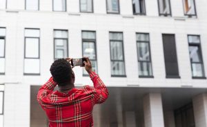 Man taking photo of a building | Financing Affordable Housing in Real Estate