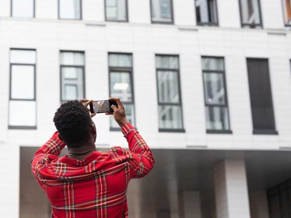 Man taking photo of a building | Financing Affordable Housing in Real Estate